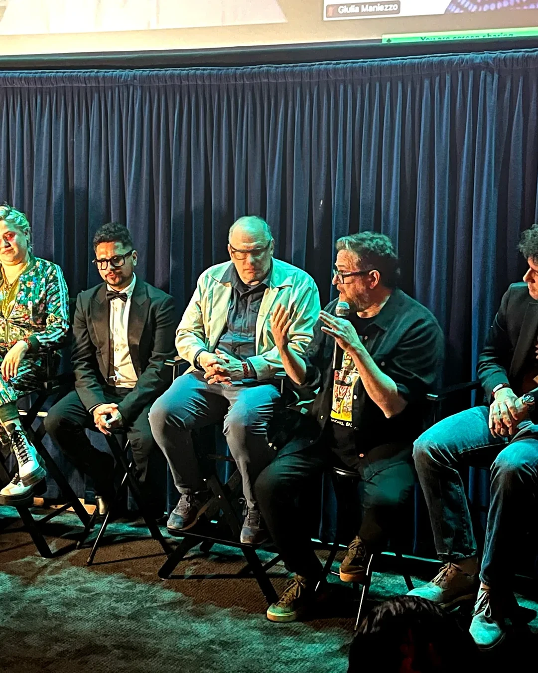 A panel of five speakers on stage at the festival